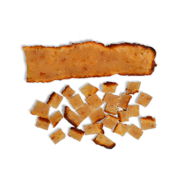 A rectangular strip of Alaskan Cod lies above several small square pieces of Alaskan Cod on a white background.